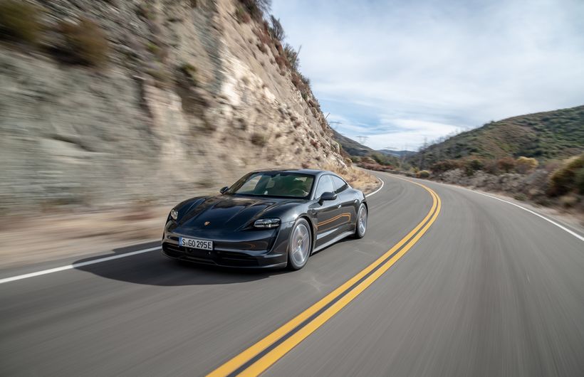 Black Porsche Taycan front and left side driving